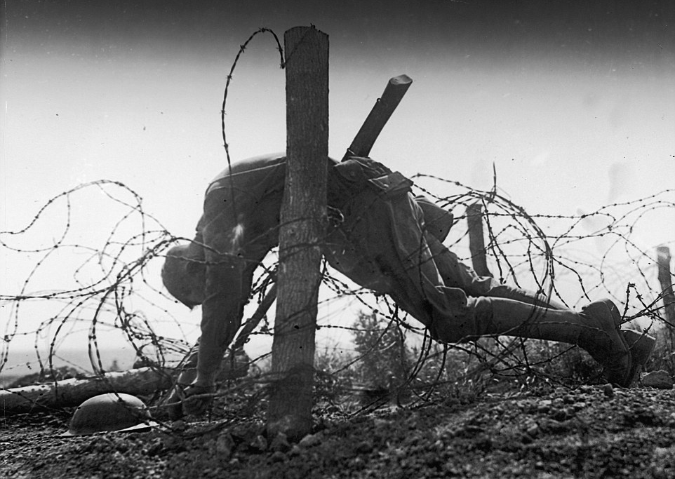 U.S. soldier in barbed wire
