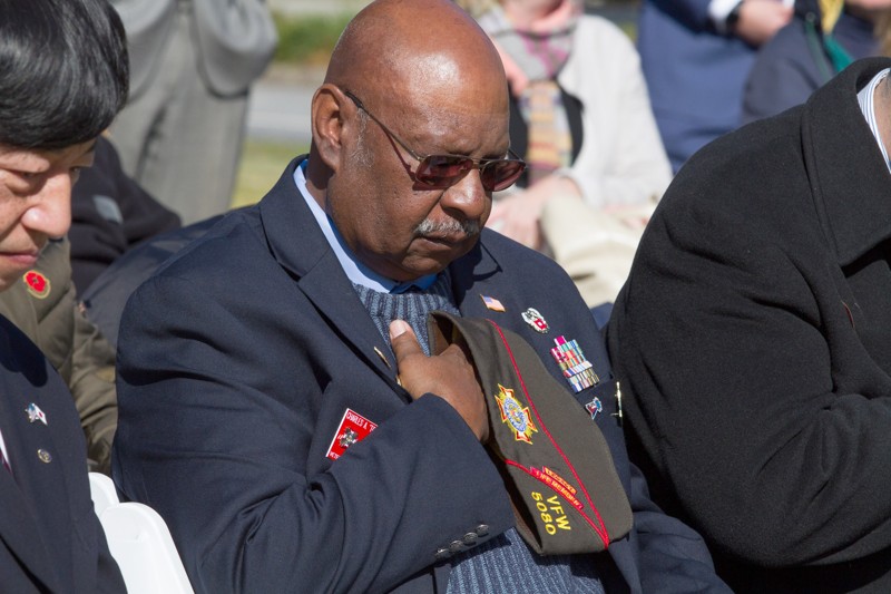 Charles A. Dobbins lowers his head throughout the invocation during the 2018 Veterans Day Commemoration