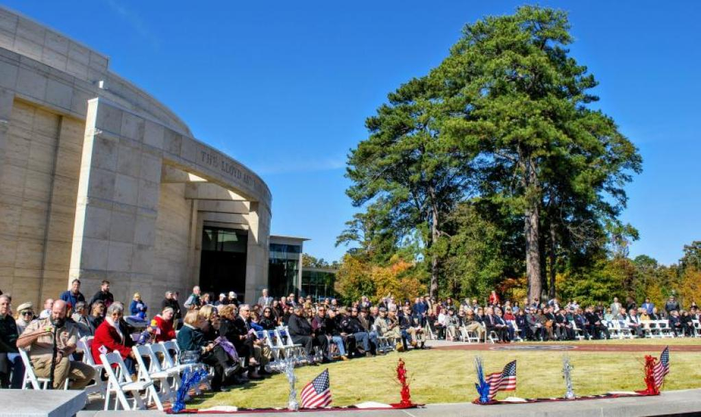 A large crowd of spectators sitting down in a semicircle