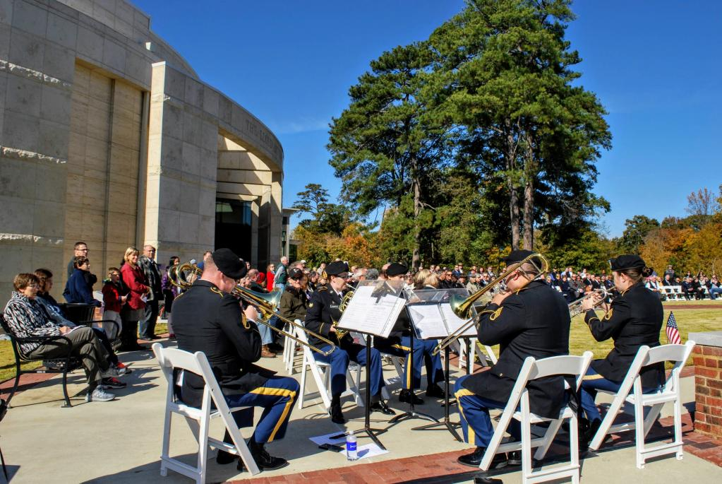 Military band playing seated in a circle