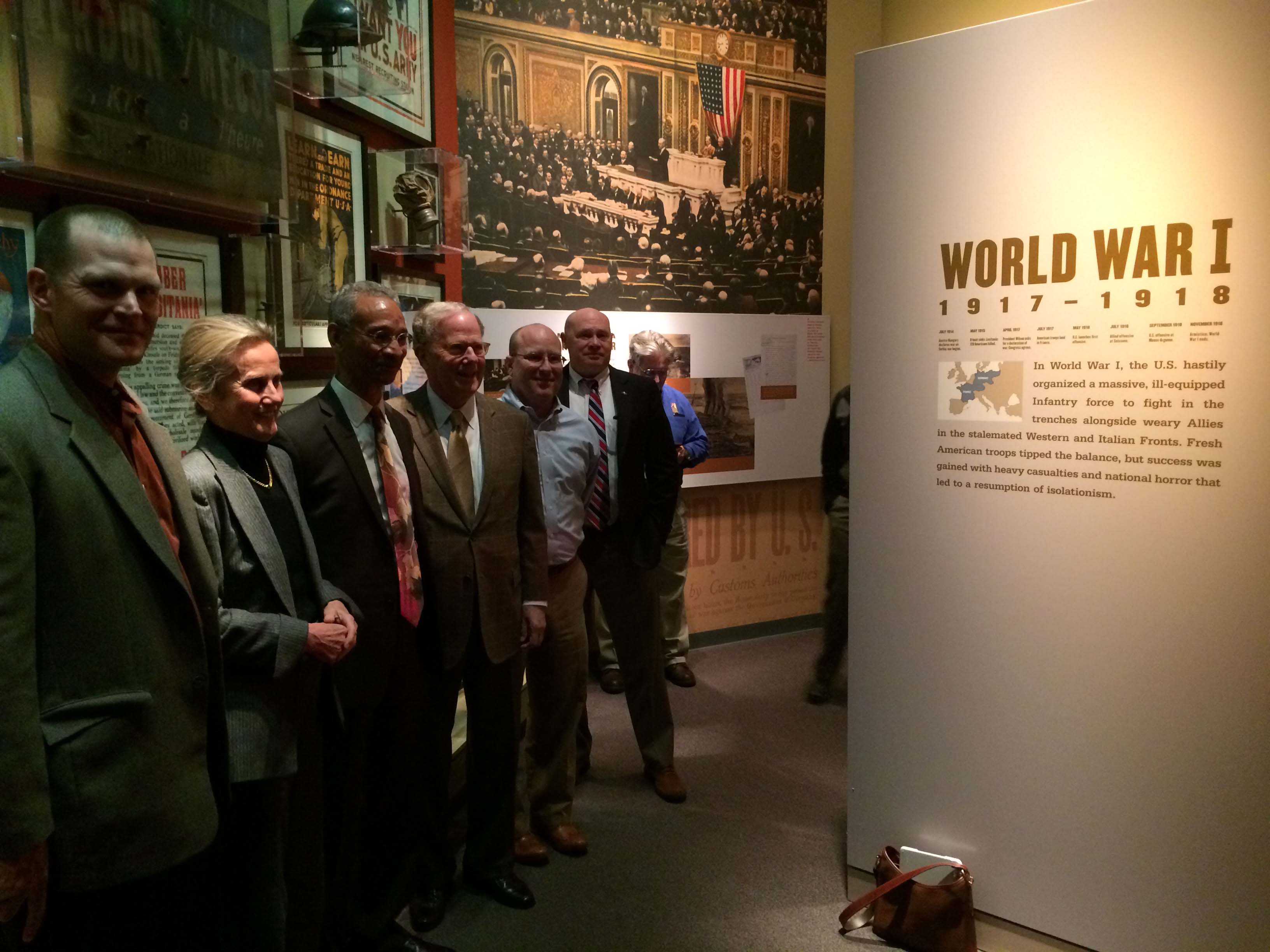 Group of people looking at plaque