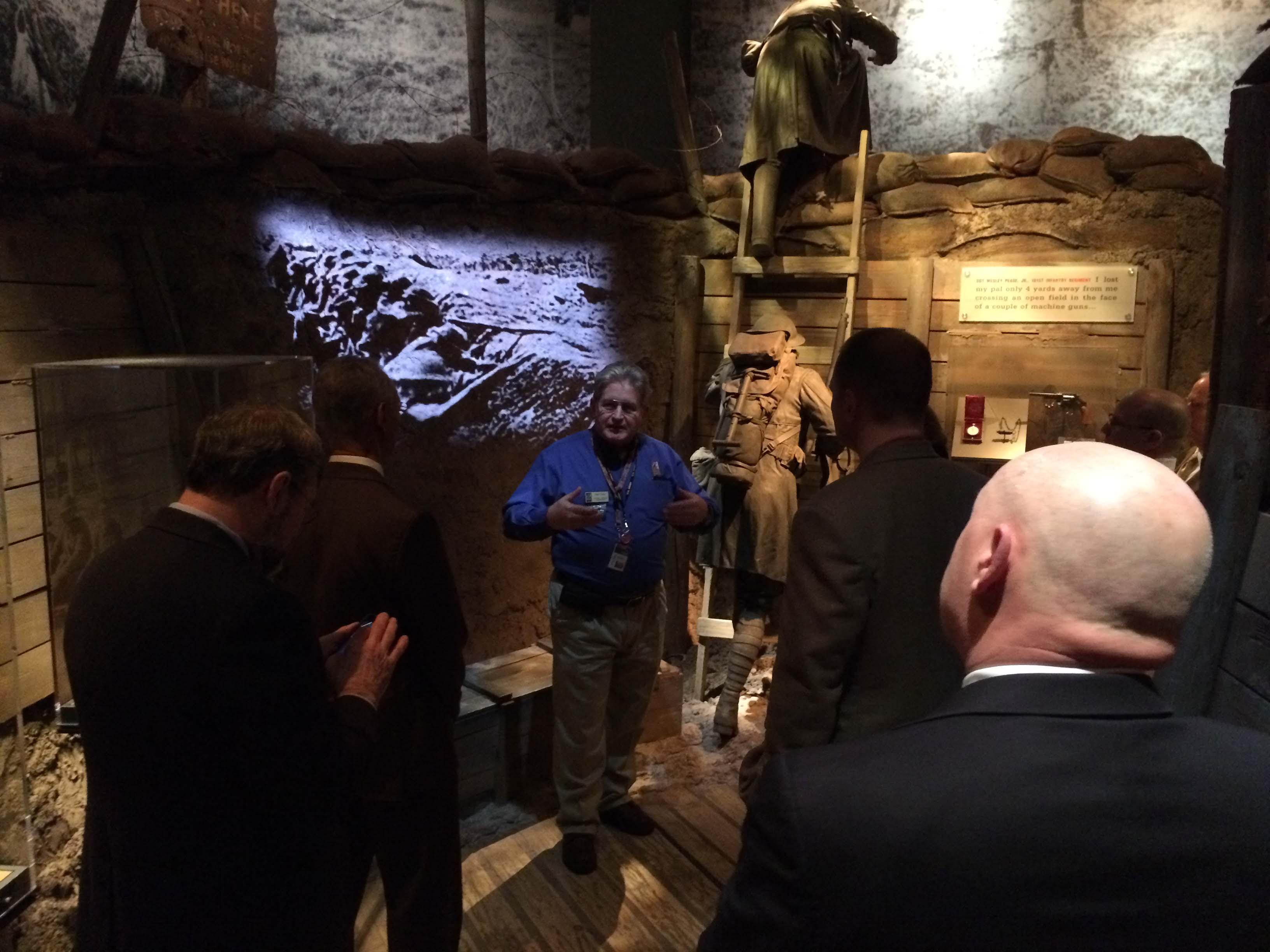 Man speaking to group of people about an exhibit