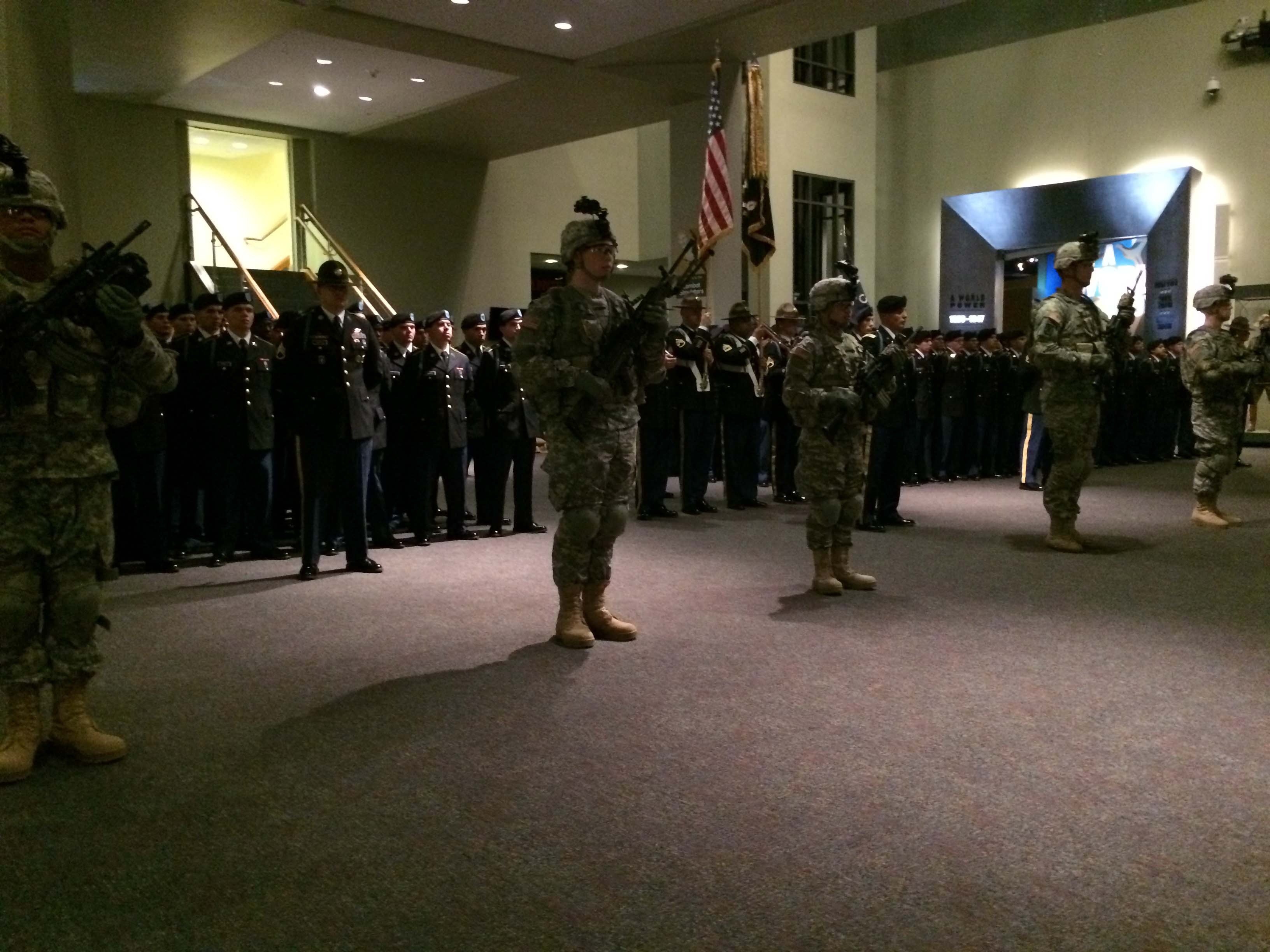 Military man holding American flag
