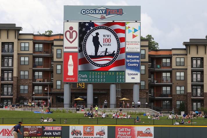 Photograph of CoolRay Field giant screen with picture of World War 1 Centennial Commission seal