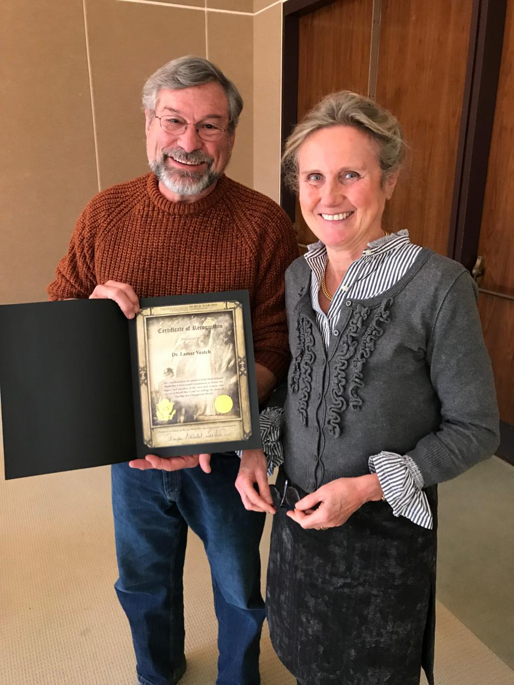 Dr. Lamar Veatch accepts a certificate of recognition from Dr. Seefried