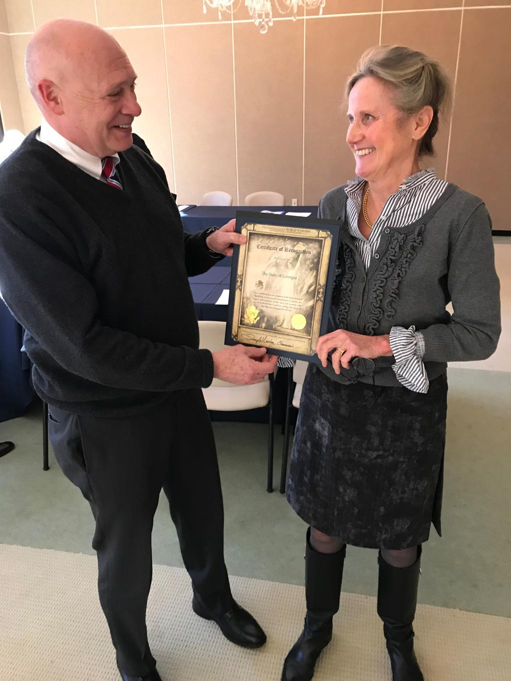 Col. Billy Wells, chair of the Georgia Commission accepts a certificate of appreciation from Dr. Seefried.