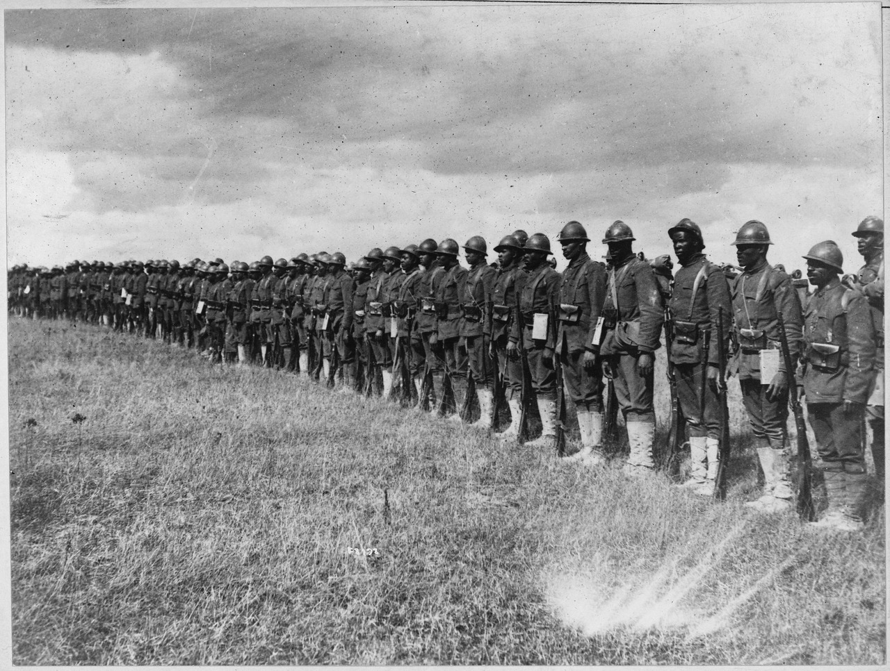 Troops of the 369th Infantry Regiment (the "Harlem Hellfighters") in line. Note their Adrian helmets and Lebel rifles, reflective of their service under French rather than American command owing to contemporary racial attitudes.