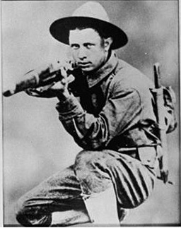 James Gresham kneels in a combat pose while training in France circa 1917.