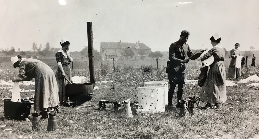 Washing bedding in wartime France, location unknown.