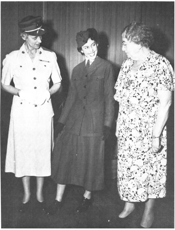 Opha Johnson (far right) and former Director of Women Marines Col. Katherine Towle examine Johnson's original Marine Corps Reserve uniform, as modeled by PFC Muriel Albert circa 1946.