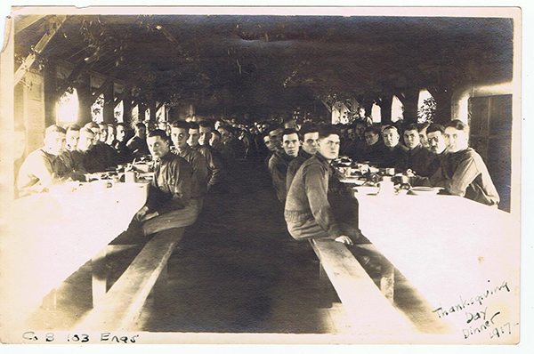 Soldiers sitting around two tables for Thanksgiving Dinner, Camp Hancock, Georgia 1917
