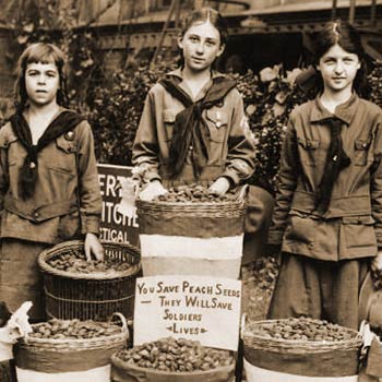 Young girls collecting peach pits used for gas mask