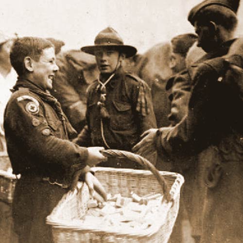 Boy Scouts give out chocolate and cigarettes to departing American troops at Winchester railway station during WWI