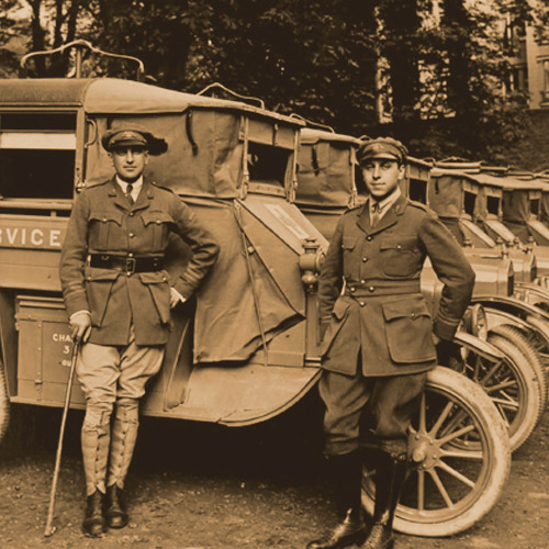 Inspector General A. Piatt Andrew and Assistant Inspector General Stephen Galatti in front of a row of ambulances at 21 rue Raynouard, the location of the AFS headquarters in Paris, France. Photograph by H.C. Ellis.